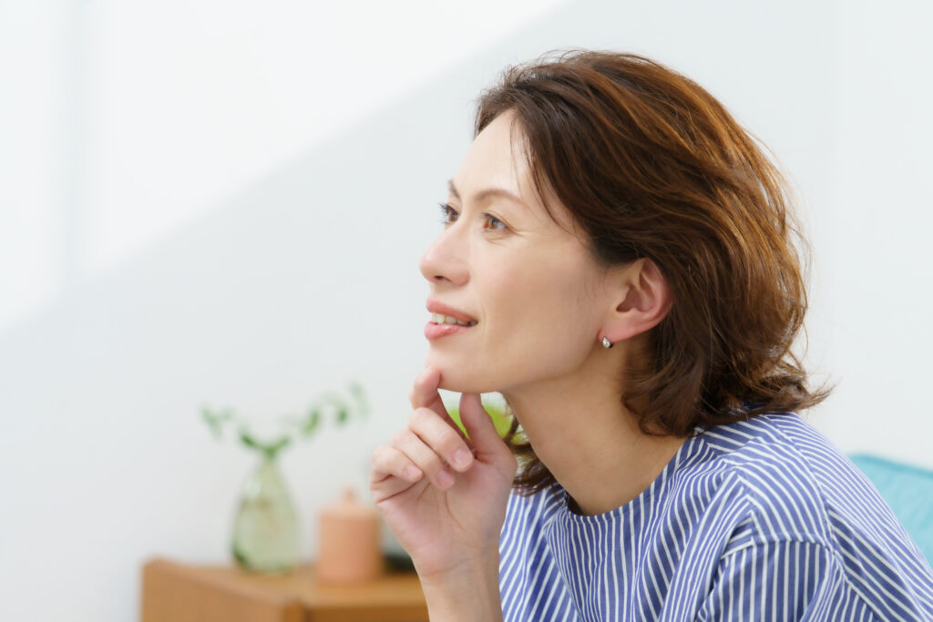 Woman with shoulder-length brown hair styled in a loose updo